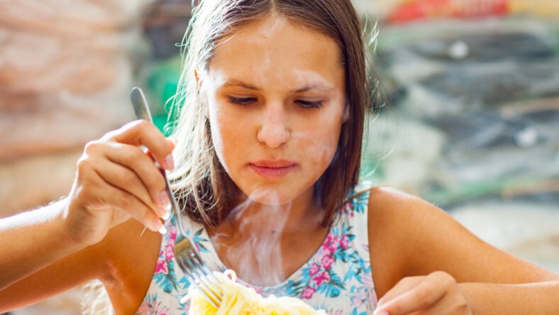 portrait of young teenager girl Eating Spaghetti