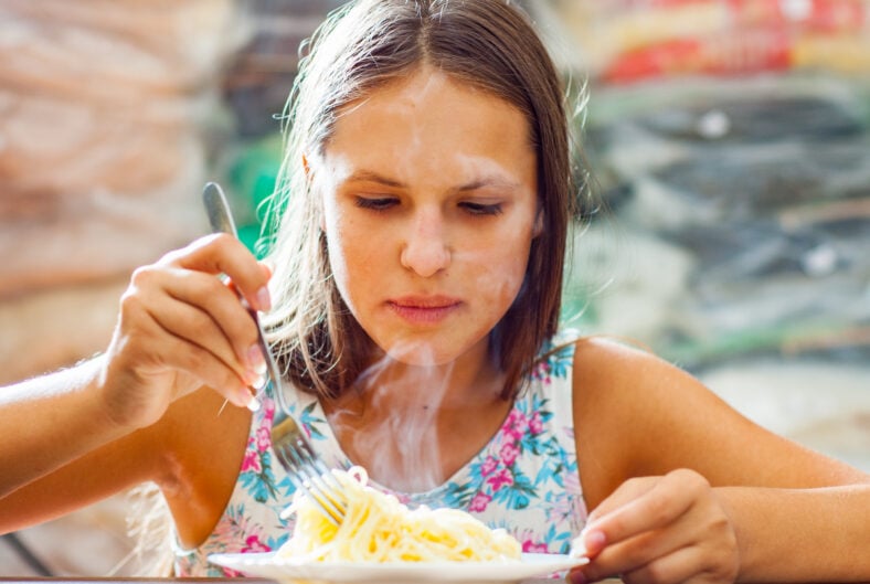 portrait of young teenager girl Eating Spaghetti