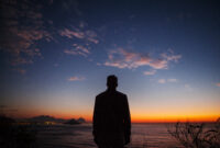 Rear view of man standing on coastal