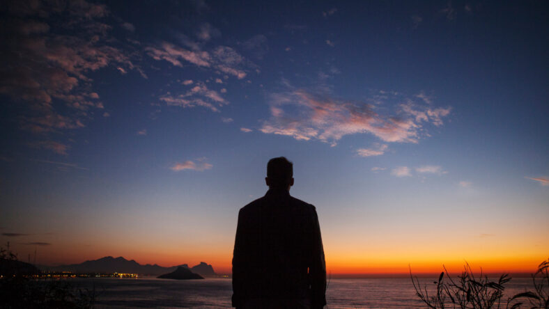 Rear view of man standing on coastal