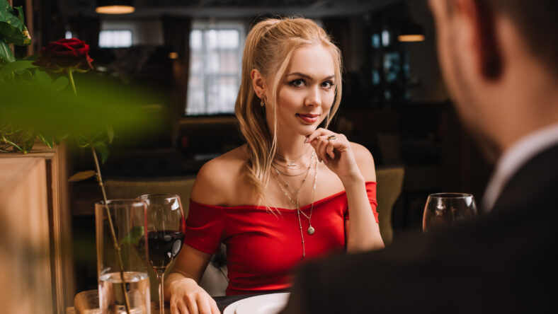 selective focus of attractive woman flirting with