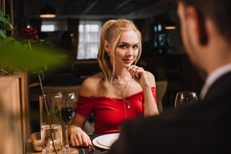 selective focus of attractive woman flirting with