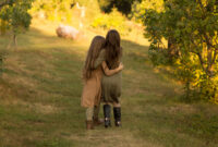 two girls hug on the street in