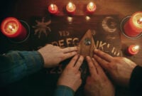 Two people conducting a seance using a