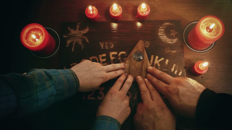 Two people conducting a seance using a