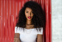 Fashionable black woman with red lips leaning