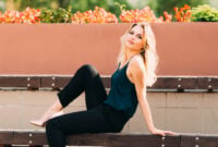 The girl is sitting on the bench