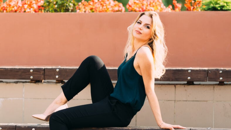 The girl is sitting on the bench