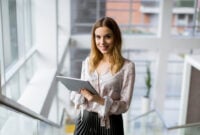 Attractive young businesswoman using a digital tablet