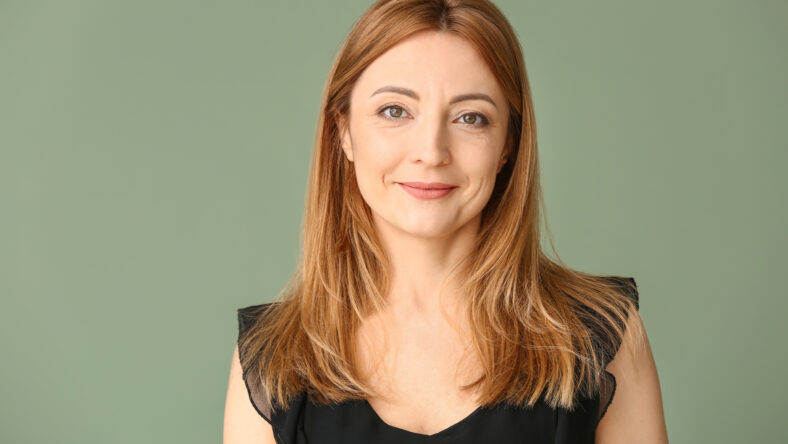 Portrait of mature woman on color background