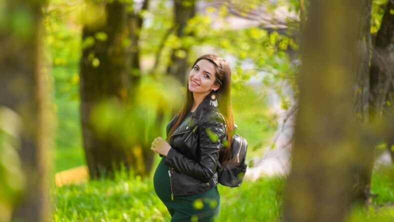 Pregnant schoolgirl. Attractive pregnant woman in dress