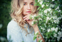 Beautiful happy young woman enjoying smell in
