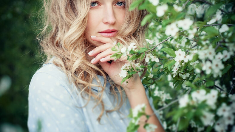 Beautiful happy young woman enjoying smell in