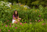 Smiling brunette girl teenager with sunflower high