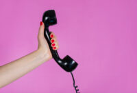 Female hand holding old and retro telephone
