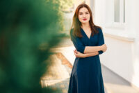 Red-haired model in a dark blue dress