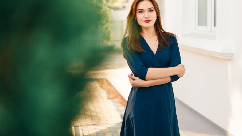 Red-haired model in a dark blue dress