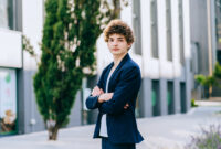 Cheerful good-looking brunet curly teenager student man