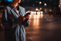Pretty girl with stylish clothes holding smartphone