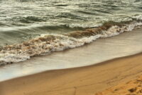 Saugatuck, Michigan, USA. Surf relentlessly massaging sand