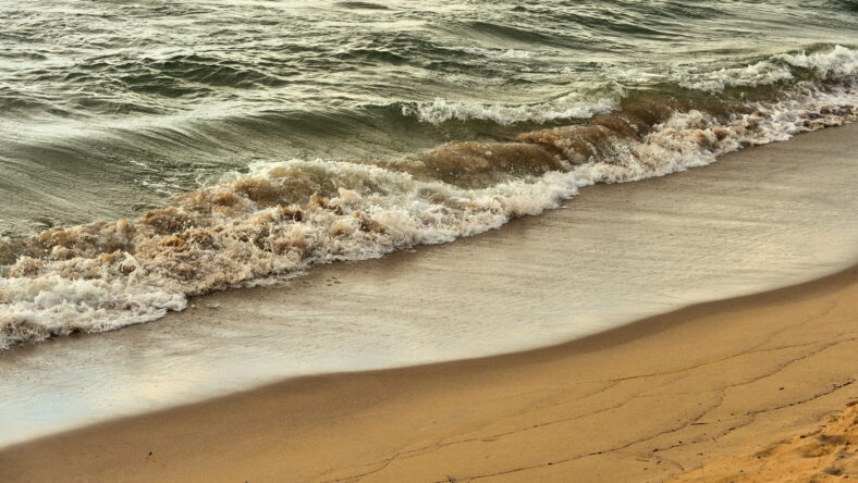 Saugatuck, Michigan, USA. Surf relentlessly massaging sand