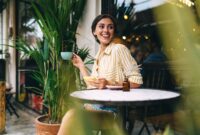 Smiling young female in casual wear drinking