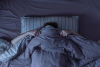 Top view of scared woman in bed