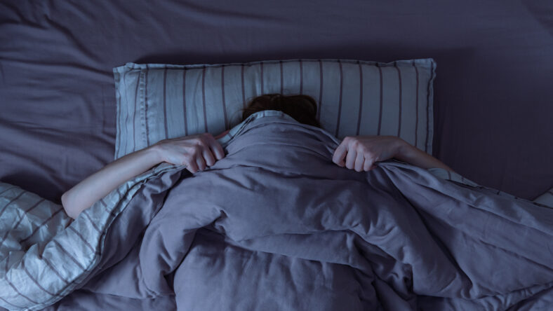 Top view of scared woman in bed