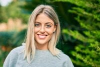 Young blonde girl smiling happy standing at