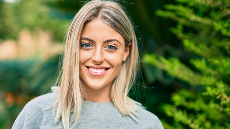 Young blonde girl smiling happy standing at