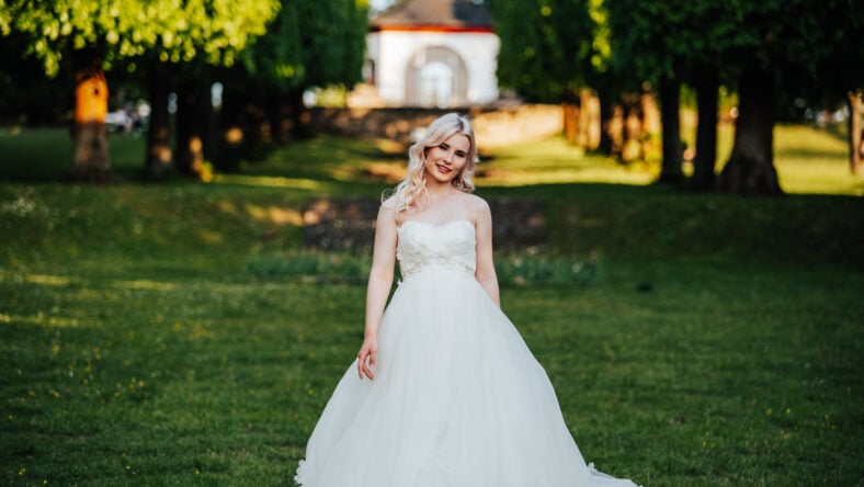 beautiful, blond bride standing and smiling in