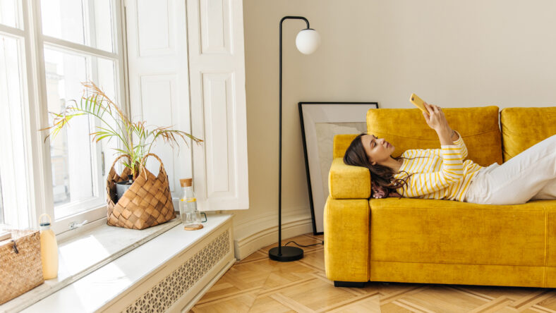 Slim caucasian young woman lying on couch
