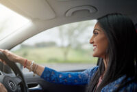 Shot of an attractive young woman driving