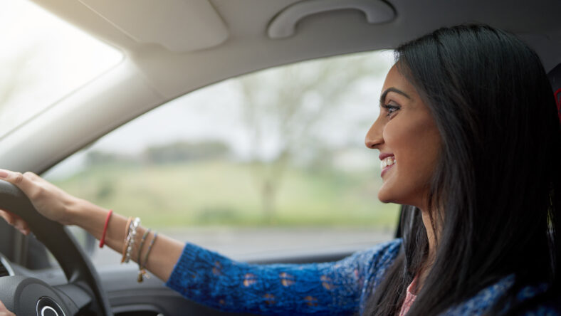 Shot of an attractive young woman driving