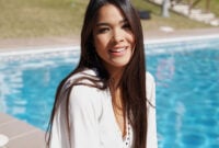 Happy young ethnic female in white shirt