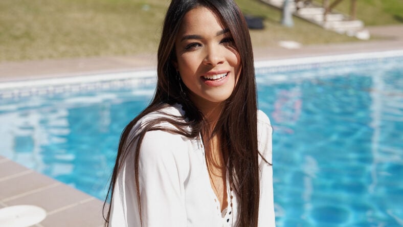 Happy young ethnic female in white shirt