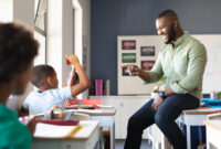 Smiling african american young male teacher gesturing