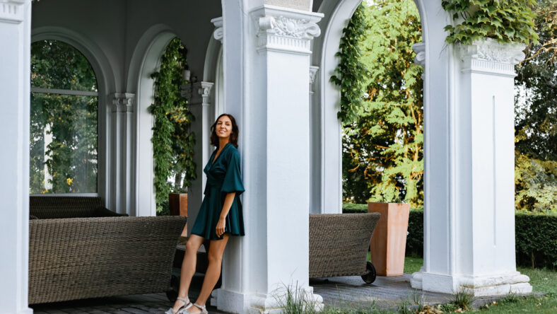 A smiling, sophisticated girl in a turquoise