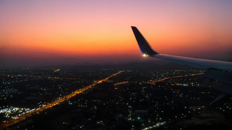 aircraft wing in the sky with sunset