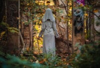 A creepy nun in a white dress.
