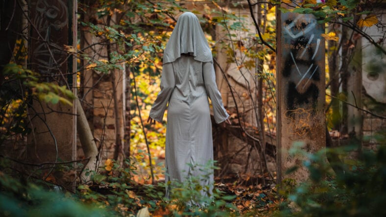 A creepy nun in a white dress.