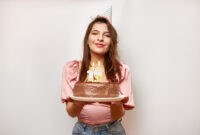 The girl is holding a festive cake