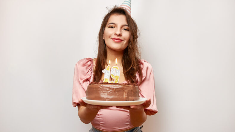 The girl is holding a festive cake