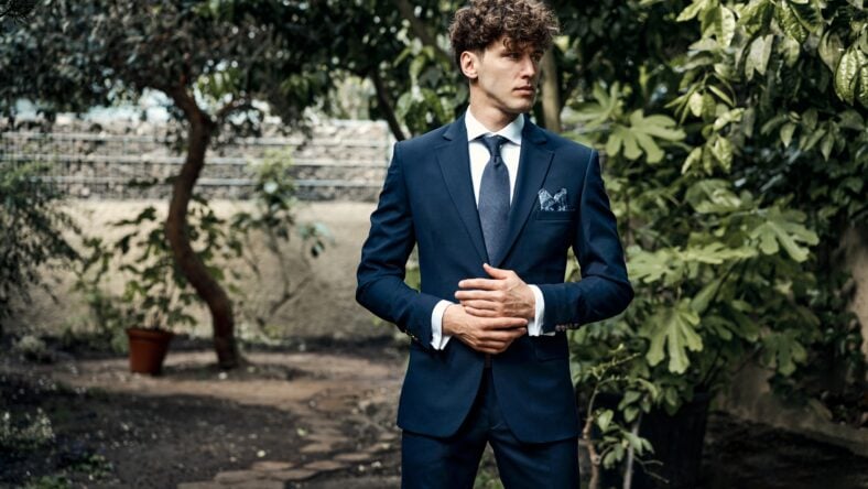 Handsome male model in blue suit standing