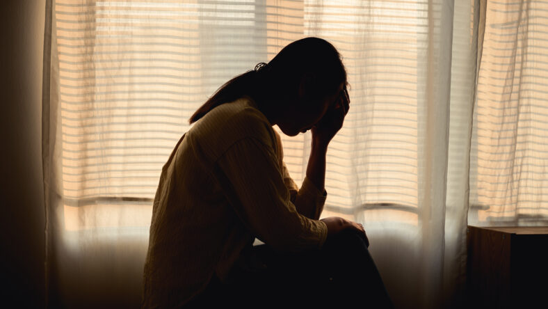 Silhouette photo of young Asian woman feeling