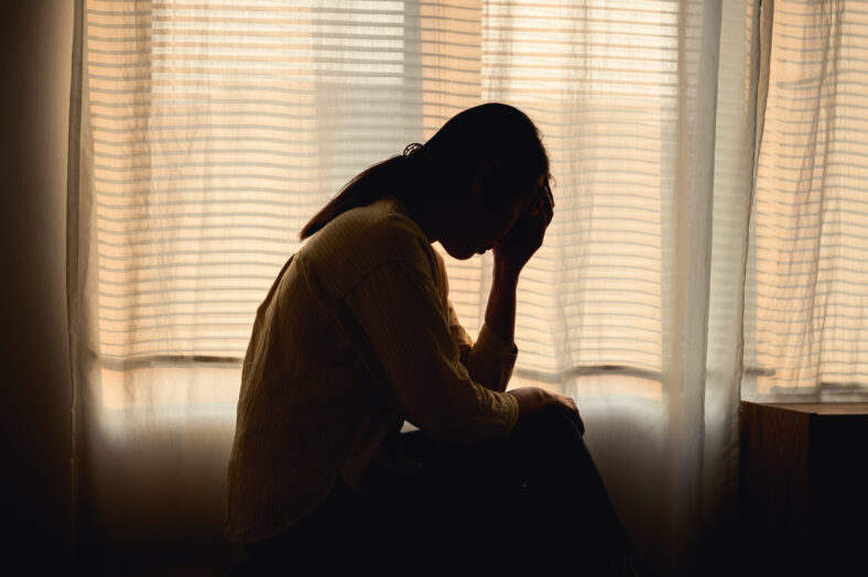Silhouette photo of young Asian woman feeling