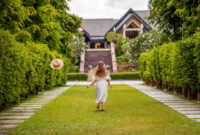 Young woman walking towards house on garden