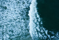Overhead view to blue stormy ocean waves