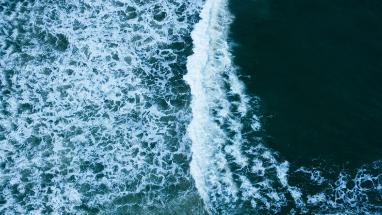 Overhead view to blue stormy ocean waves