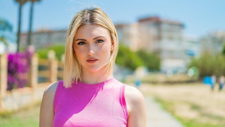 Young pretty blonde woman at outdoors . Portrait